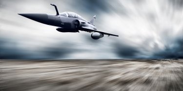 Military airplane flying at speed, via Bigstock.com