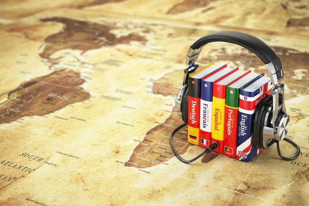 Learning languages online. Audiobooks concept. Books and headphones on the map world. 3d