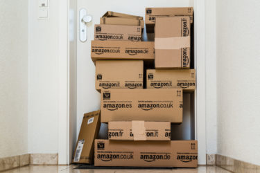 Amazon packages in front of an apartment.