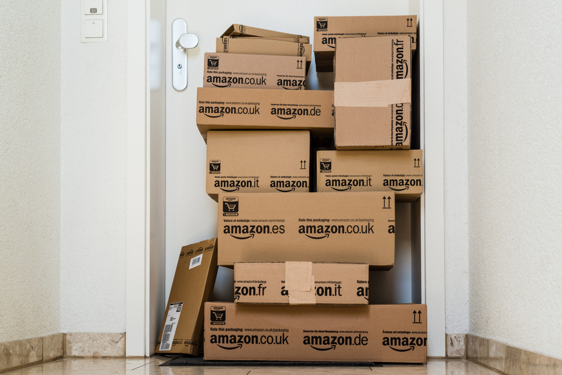 Amazon packages in front of an apartment.